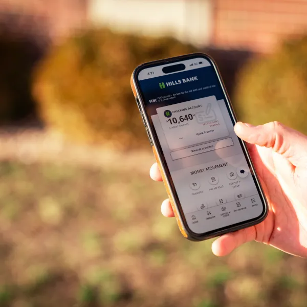 Online banking features being shown up close in the app by an individual.